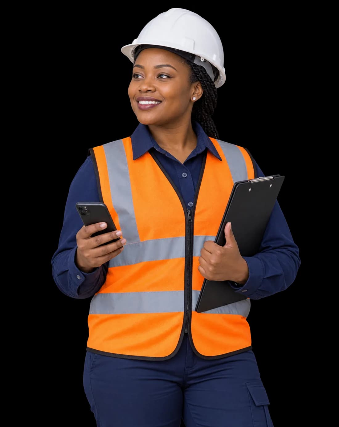 A smiling safety supervisor in a hard hat and hi-vis vest holding a phone